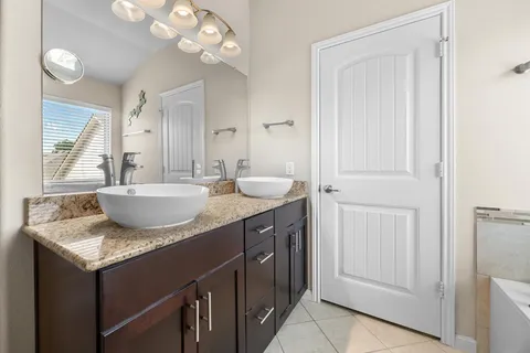 a kitchen with a counter space appliances and a living room