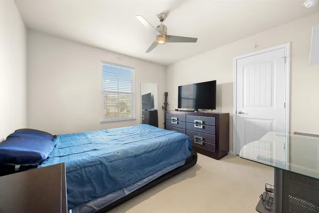 a bedroom with a bed and a television