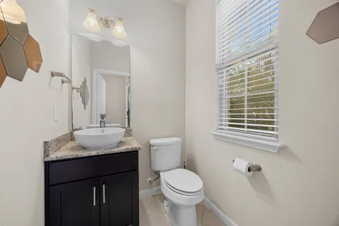 a bedroom with a bed and a flat tv screen on dresser