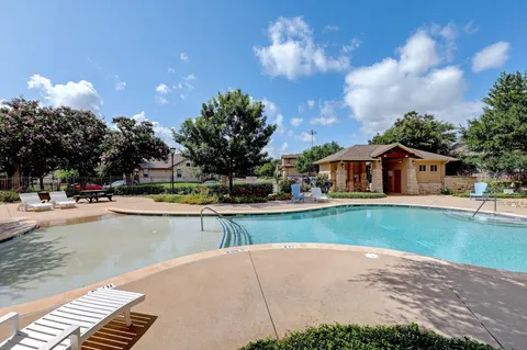 a view of a house with backyard and porch