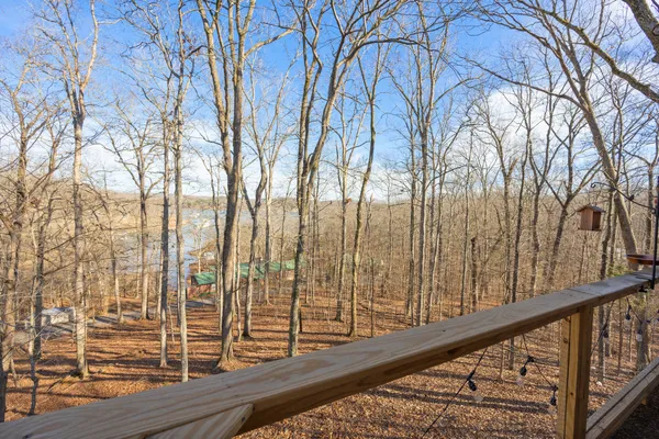 a view of balcony with wooden floor and fence