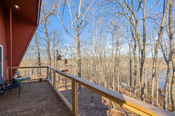 a large kitchen with kitchen island granite countertop a large window and stainless steel appliances