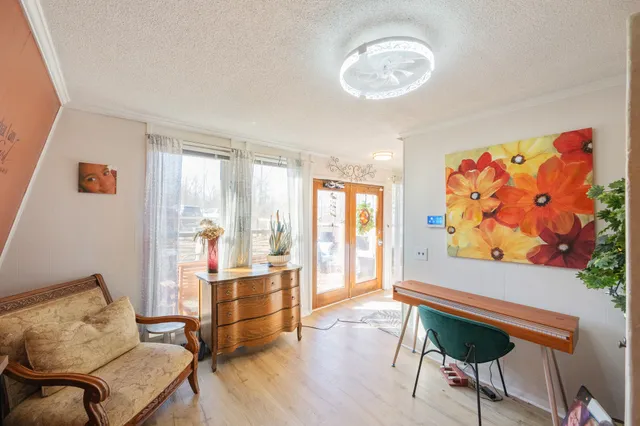 a living room with furniture and a chandelier