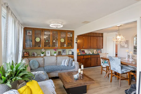 a kitchen with stainless steel appliances a refrigerator a stove a sink dishwasher and wooden cabinets with wooden floor