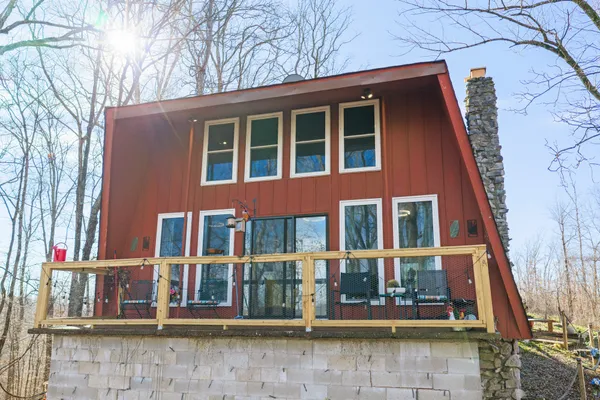 a front view of a house with outdoor seating