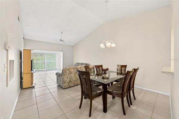 a dining room with furniture and a large window