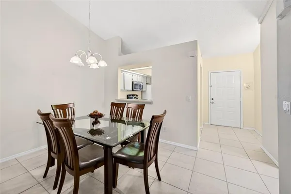a view of a dining room with furniture and chandelier