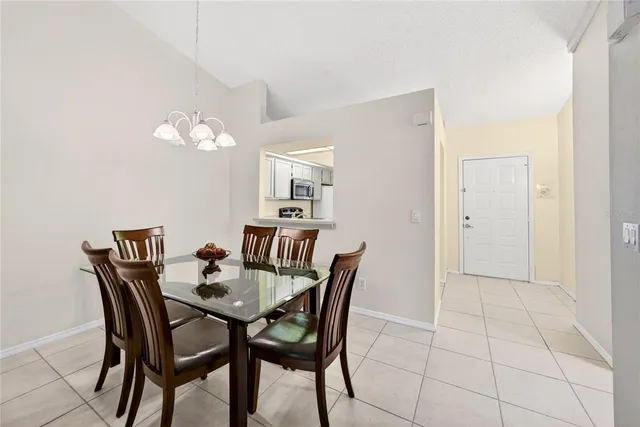 a view of a dining room with furniture and chandelier