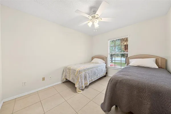 a spacious bedroom with a bed and a chandelier