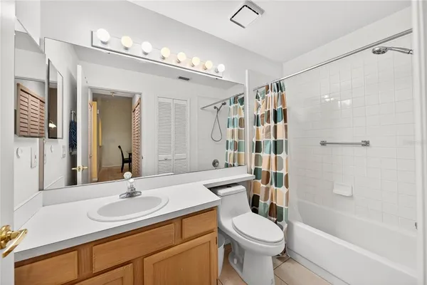 a bathroom with a sink toilet tub and shower