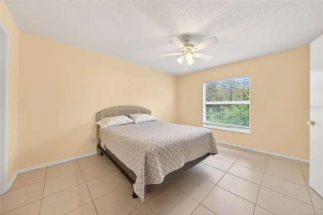 a spacious bedroom with a bed and a window
