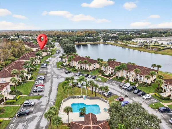 an aerial view of lake and residential houses with outdoor space