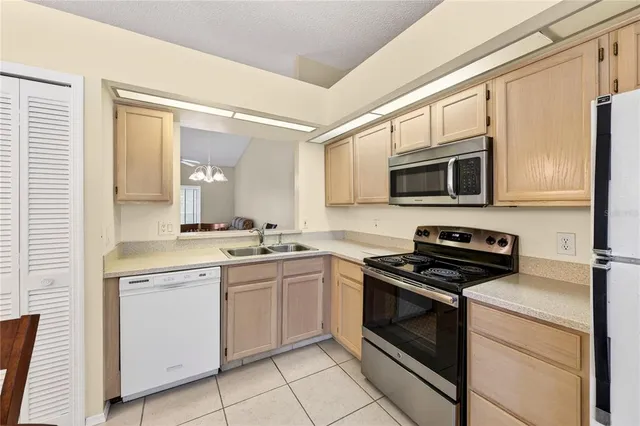 a kitchen with a sink stove and microwave