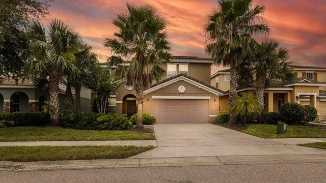 a front view of a house with a yard and a garage