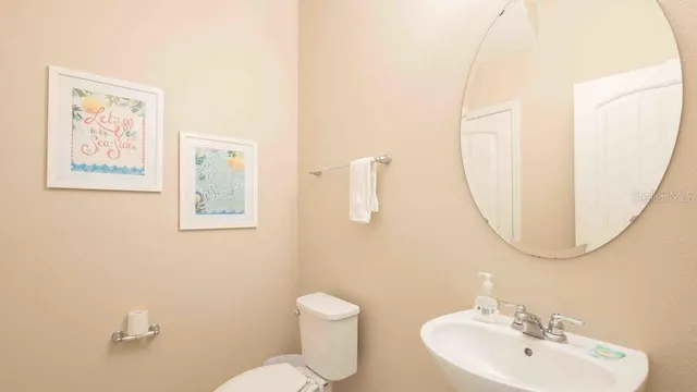 a bedroom with a bed and dresser with mirror