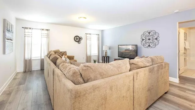 a living room with furniture and a flat screen tv
