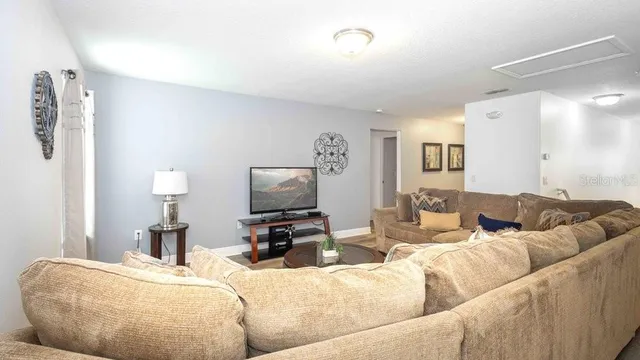 a bedroom with two beds and painting on the wall