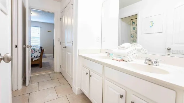 a bedroom with bed and two windows