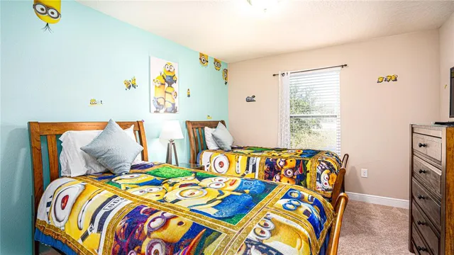 a bedroom that has a bed and a dresser in it