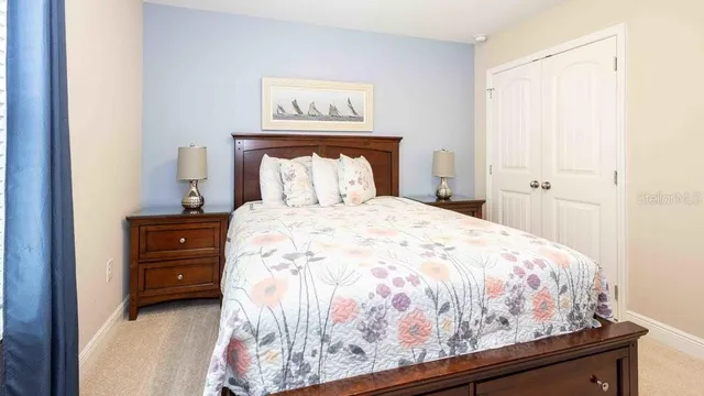 a bedroom with a bed and a night stand