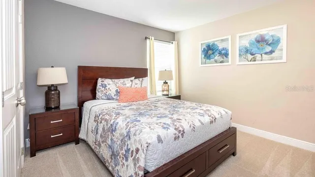 a bedroom with a bed and dresser with mirror