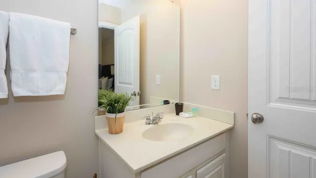 a bathroom with a sink toilet and mirror