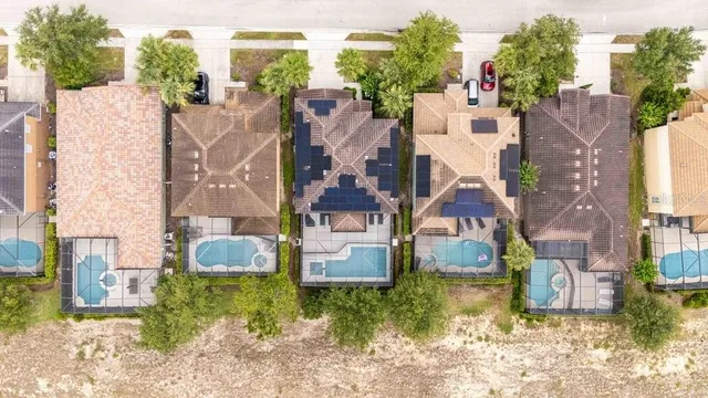an aerial view of residential houses with outdoor space