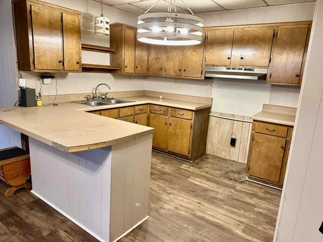 a kitchen with stainless steel appliances a sink stove and refrigerator