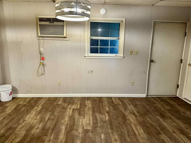 a view of wooden floor and windows in a room