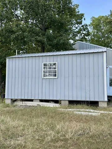 a view of small backyard with wooden fence