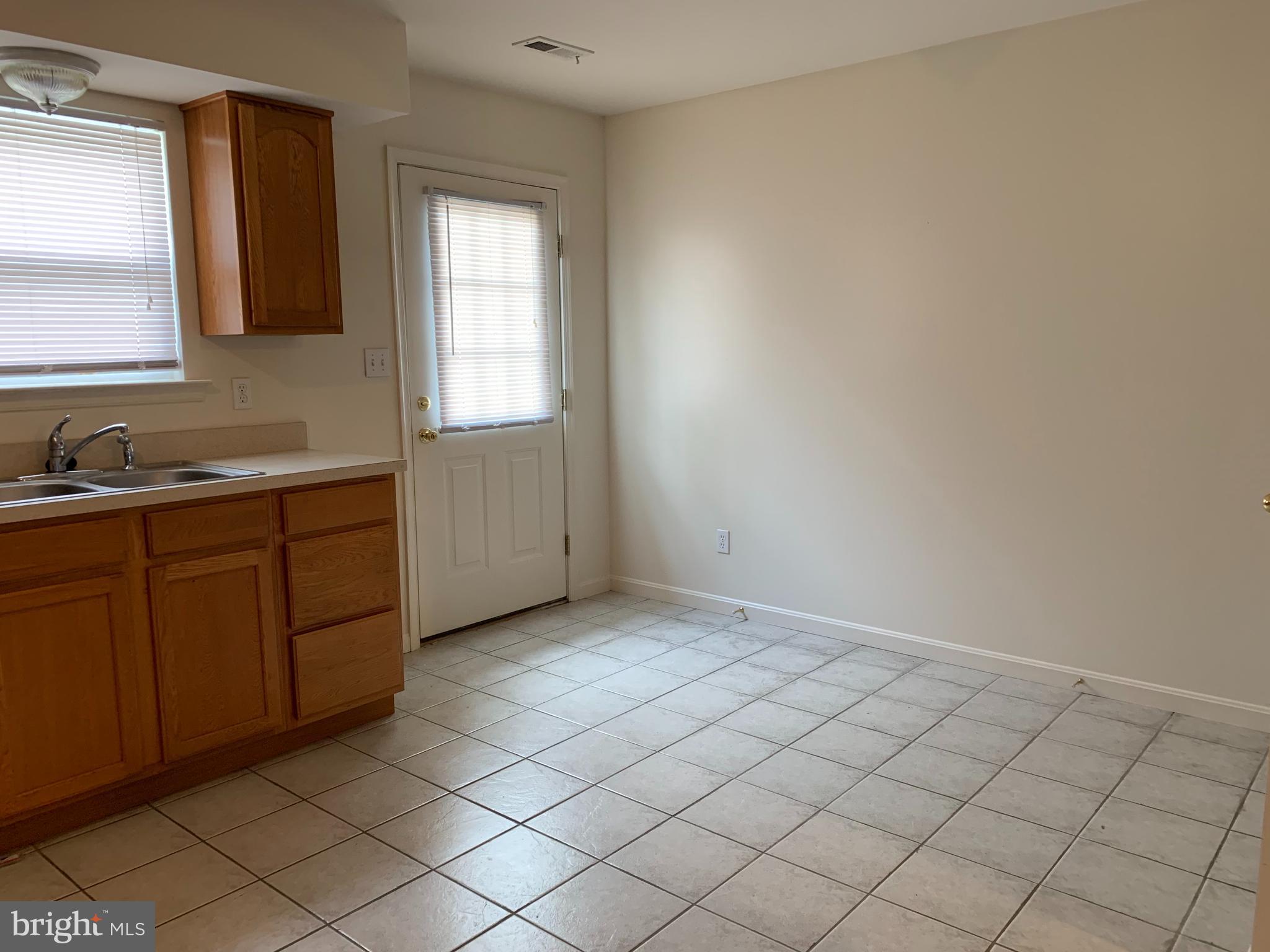 3916 6th Street, Unit B North Beach, MD 20714 - Photo 2 of 5 a view of a kitchen with white cabinets