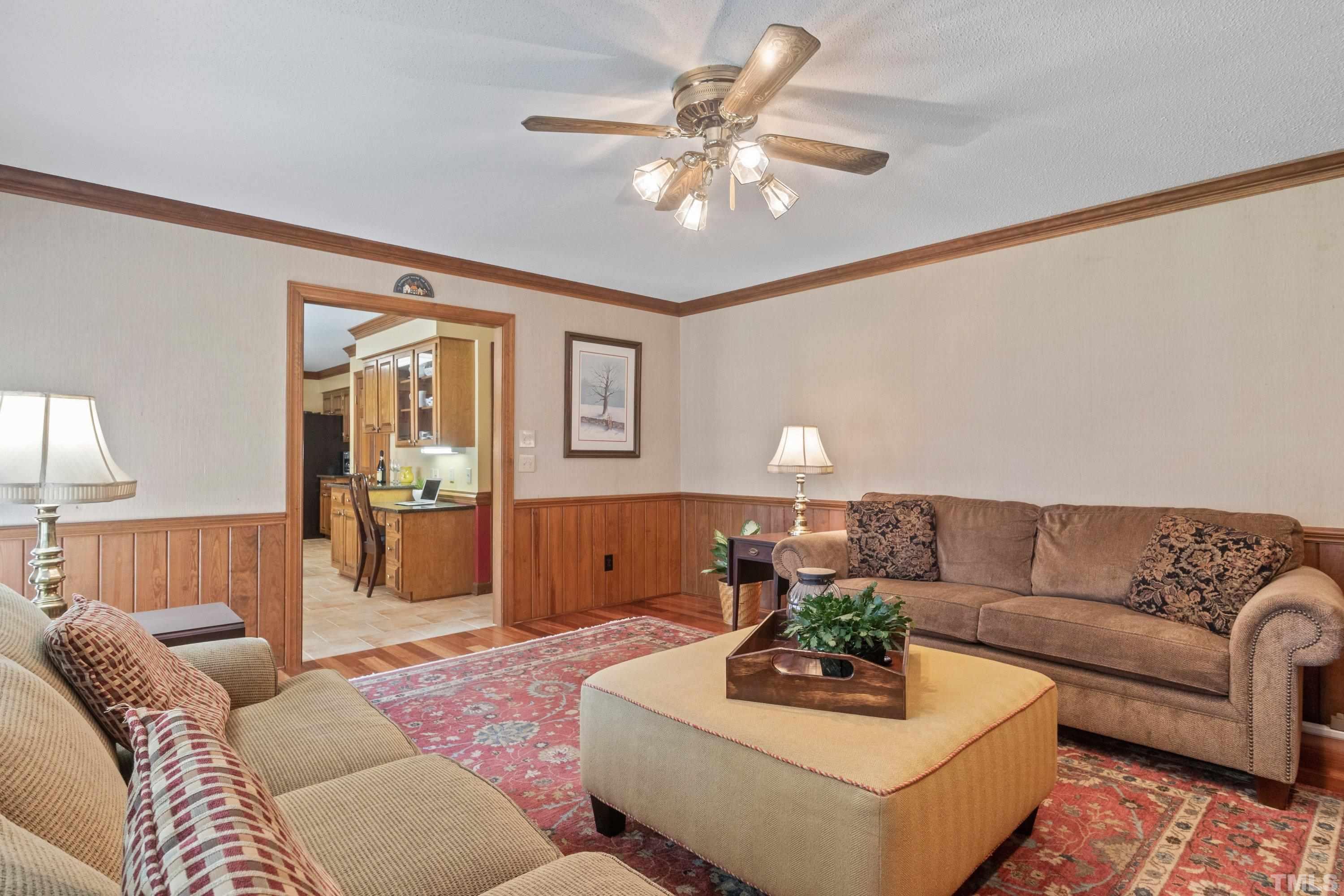 8501 Crowder Road Raleigh, NC 27603 - Photo 23 of 60 a living room with furniture and a chandelier