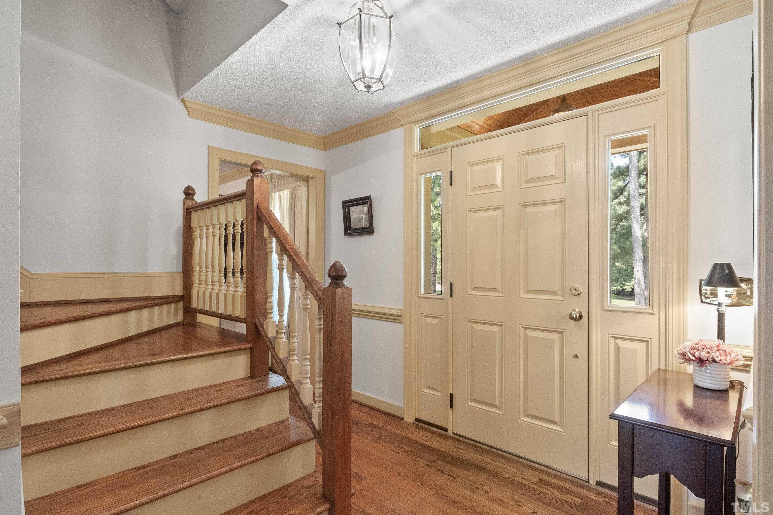 8501 Crowder Road Raleigh, NC 27603 - Photo 8 of 60 a view of entryway with wooden floor and livingroom view