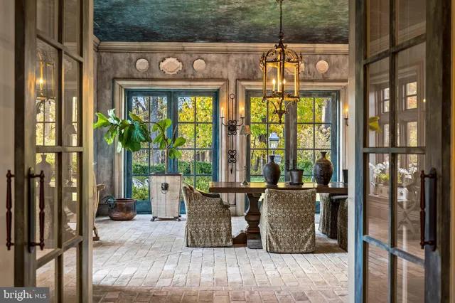a view of a living room with a floor to ceiling window and wooden floor
