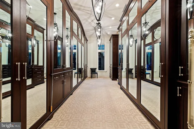 a living room with stainless steel appliances kitchen island granite countertop furniture a fireplace and a chandelier