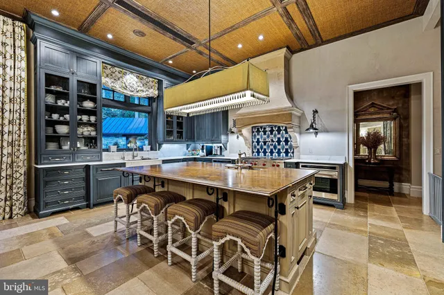a living room with furniture a chandelier and a flat screen tv