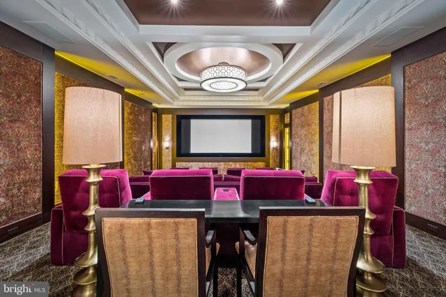 a view of a patio with table and chairs under an umbrella with large trees