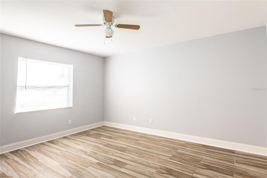 12417 84th Way Largo, FL 33773 - Photo 11 of 27 an empty room with a window and a ceiling fan