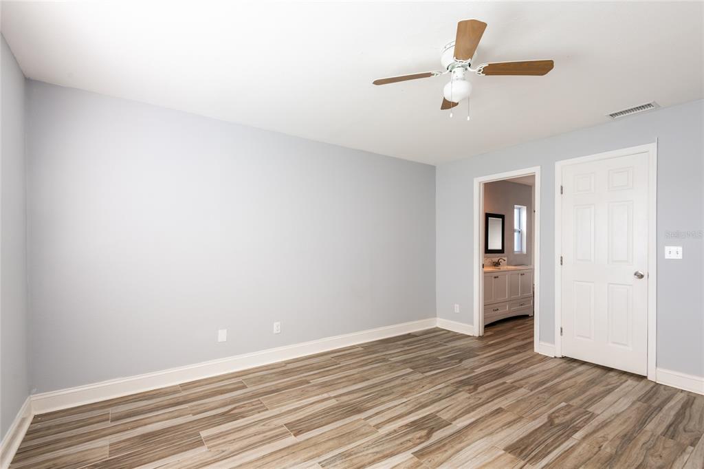 12417 84th Way Largo, FL 33773 - Photo 12 of 27 a view of a room with wooden floor and a ceiling fan