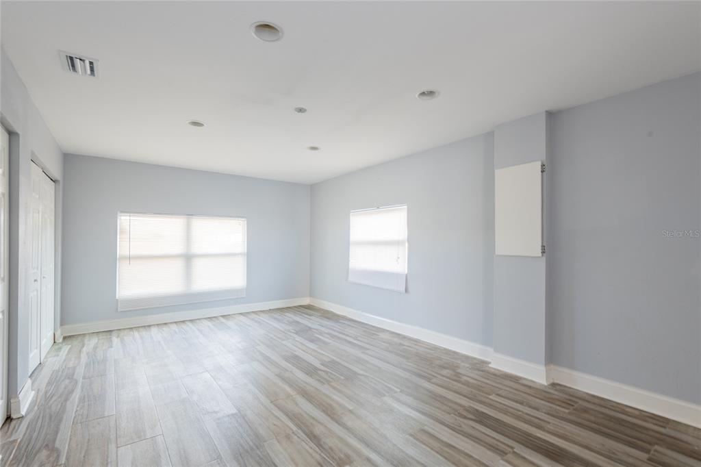 12417 84th Way Largo, FL 33773 - Photo 16 of 27 a view of empty room with window and wooden floor