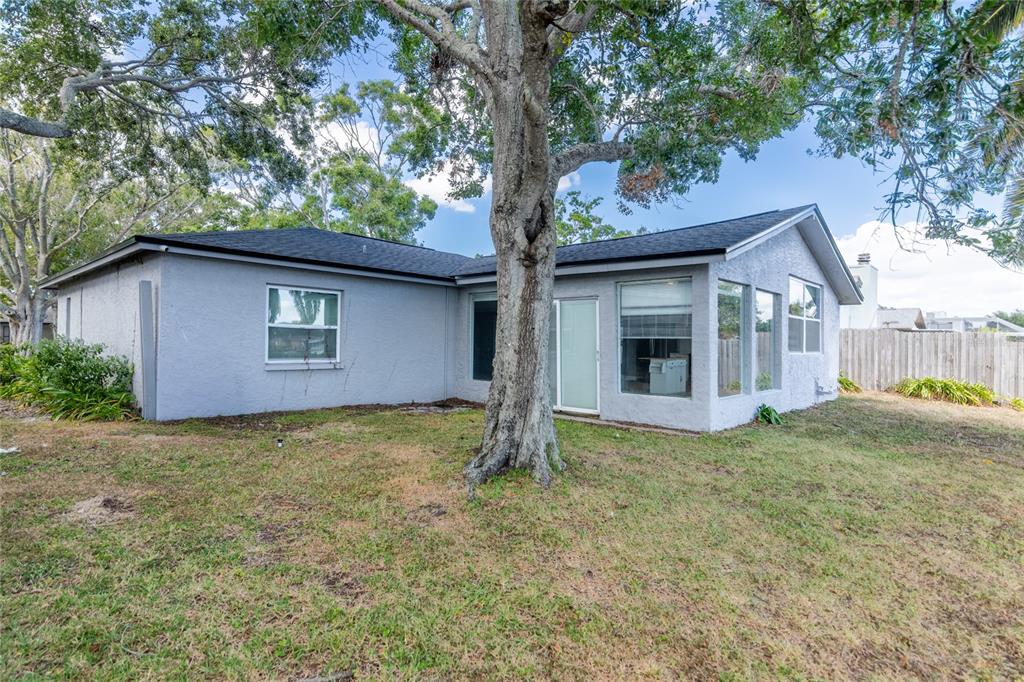 12417 84th Way Largo, FL 33773 - Photo 20 of 27 a house with trees in the background