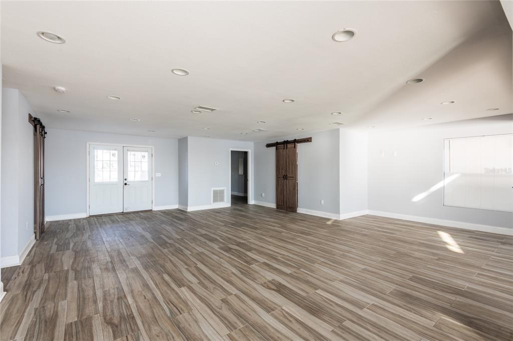 12417 84th Way Largo, FL 33773 - Photo 8 of 27 a view of an empty room with wooden floor and window