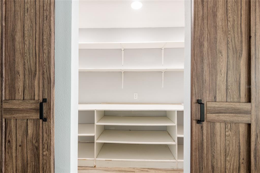 12417 84th Way Largo, FL 33773 - Photo 9 of 27 a view of walk in closet with empty racks
