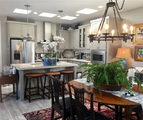 a kitchen with a table chairs stove and kitchen view