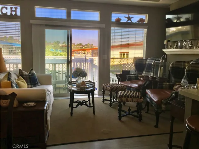 a living room with furniture large window and flat screen tv