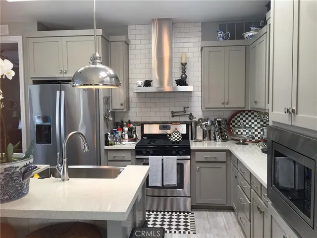 a kitchen with a sink stove and refrigerator