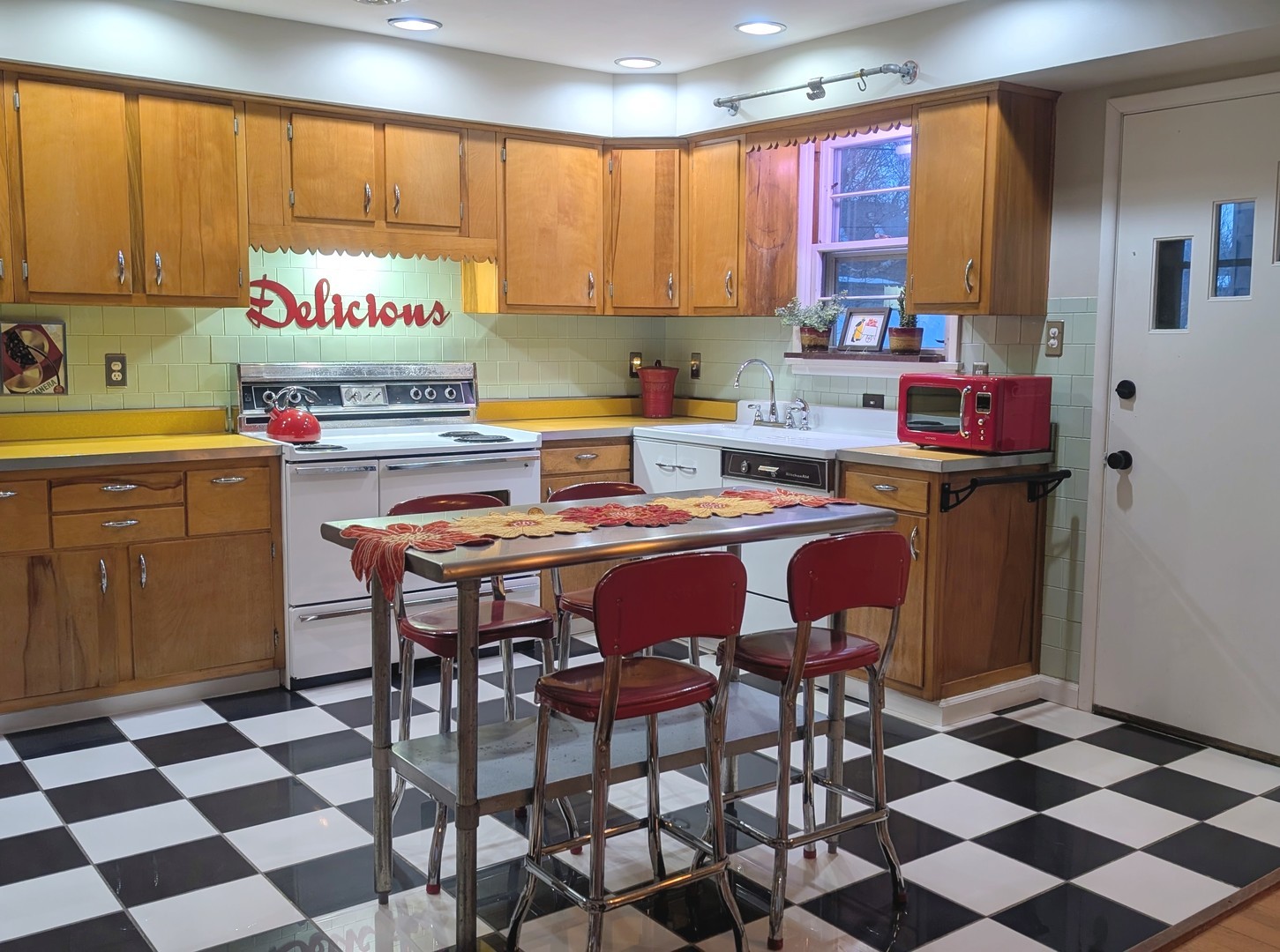 1111 West John Street Champaign, IL 61821 - Photo 12 of 39 a kitchen with a sink a stove and chairs