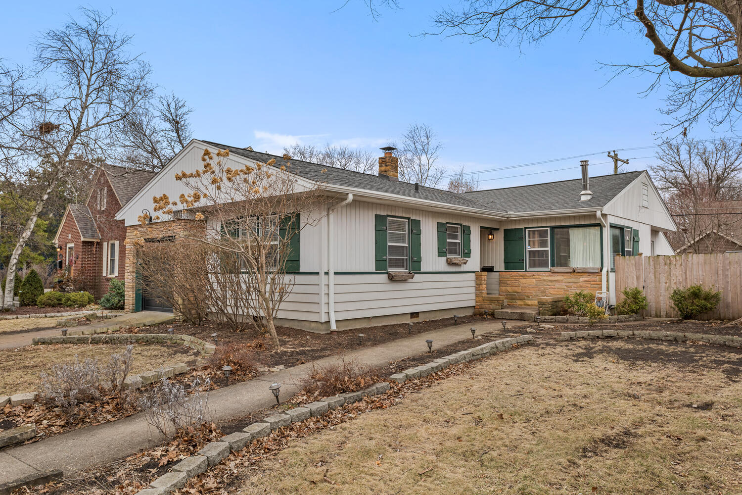 1111 West John Street Champaign, IL 61821 - Photo 3 of 39 a view of a white house next to a yard with big trees