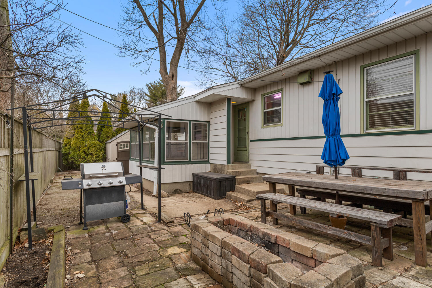 1111 West John Street Champaign, IL 61821 - Photo 37 of 39 a view of a patio with table and chairs with wooden fence and plants