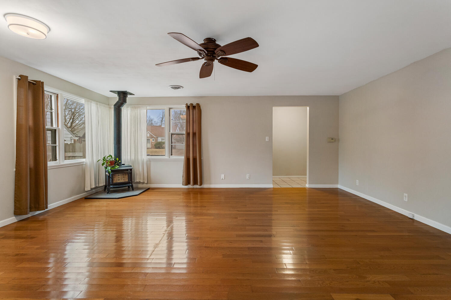 1111 West John Street Champaign, IL 61821 - Photo 6 of 39 a view of an empty room with window and wooden floor